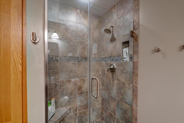 bathroom with a shower with shower door