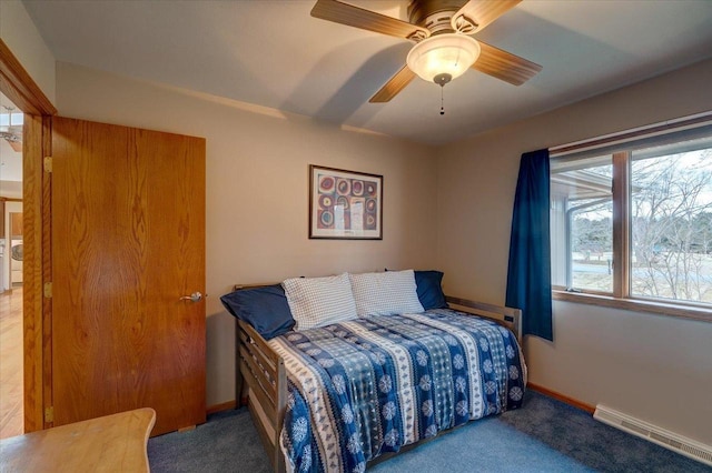 carpeted bedroom with ceiling fan and a baseboard radiator