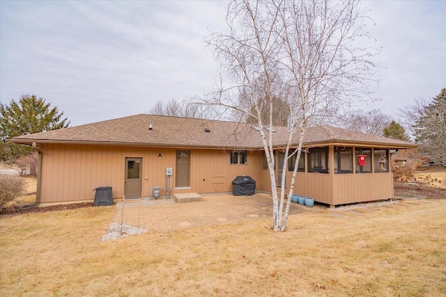 back of house featuring a sunroom, a yard, and a patio area