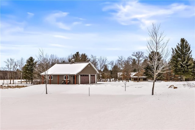 snowy yard with a garage