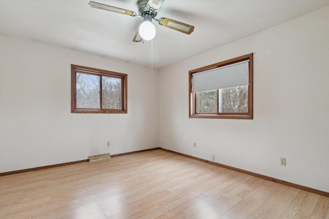 empty room featuring ceiling fan and light hardwood / wood-style flooring