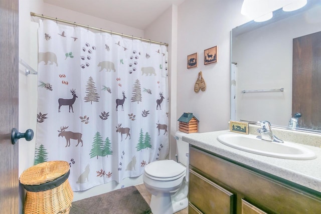 bathroom with vanity, curtained shower, and toilet