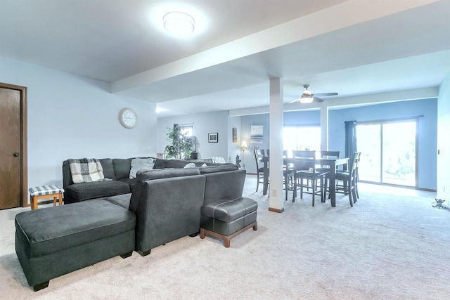 carpeted living room featuring ceiling fan