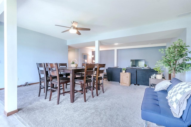 carpeted dining space with ceiling fan