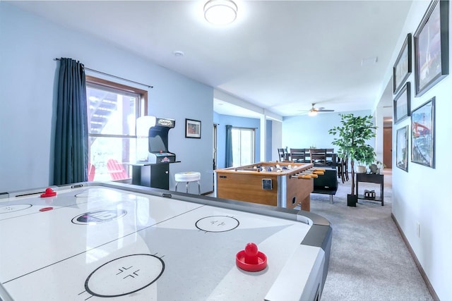 recreation room with carpet flooring and ceiling fan