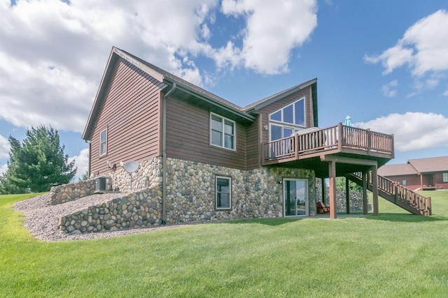 back of property featuring a wooden deck, a yard, and central AC