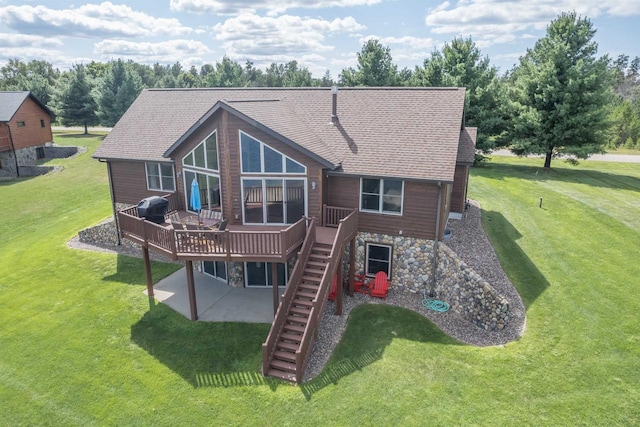 back of property featuring a wooden deck, a lawn, and a patio area