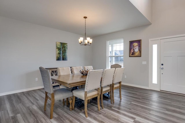 dining space featuring hardwood / wood-style floors and a notable chandelier