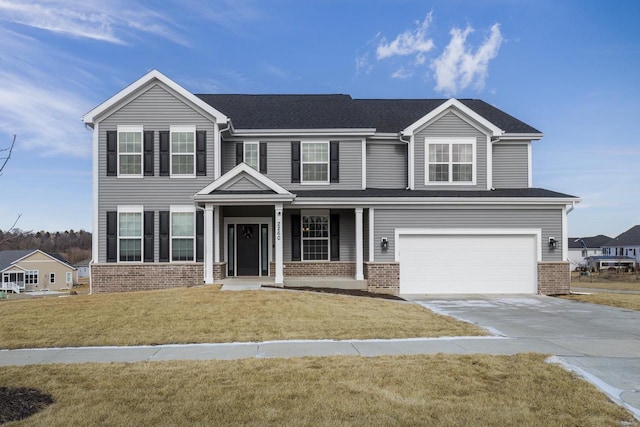 view of front of home with a garage and a front lawn