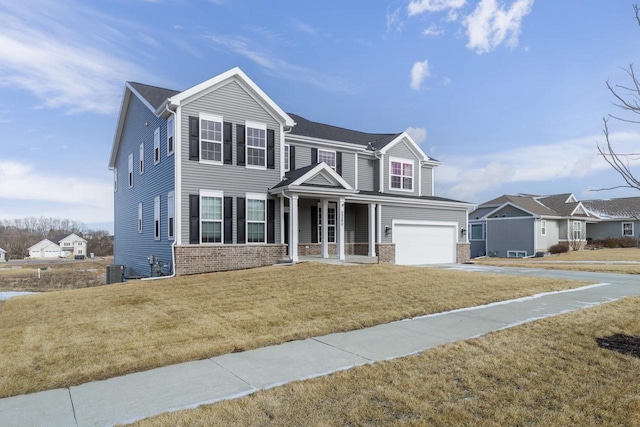 view of front of home with a garage, a front lawn, and a porch