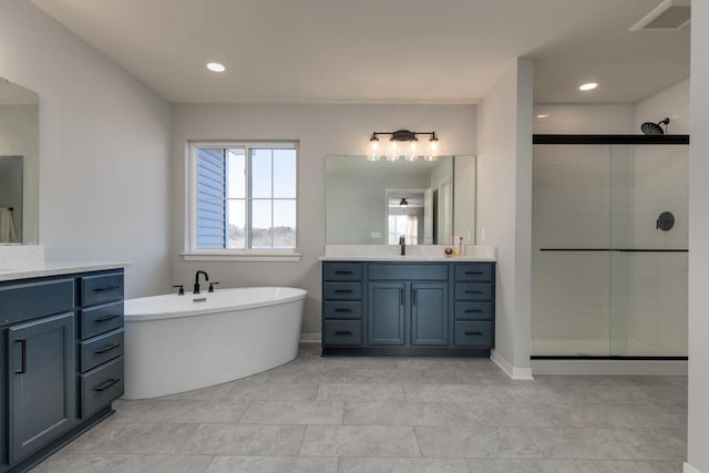 bathroom with vanity and shower with separate bathtub