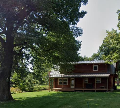 rear view of property featuring a lawn