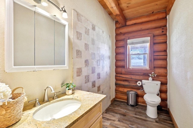 bathroom with vanity, hardwood / wood-style flooring, wooden ceiling, and rustic walls