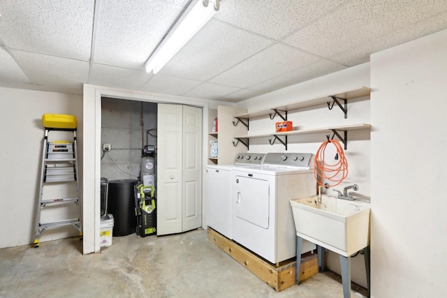 clothes washing area with sink and washer and clothes dryer