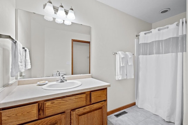 bathroom with tile patterned floors and vanity