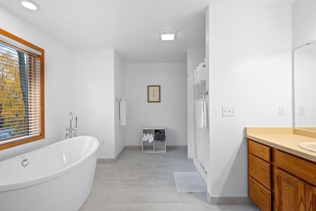 bathroom featuring vanity, plenty of natural light, and plus walk in shower