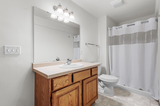 bathroom with vanity, tile patterned flooring, toilet, and walk in shower