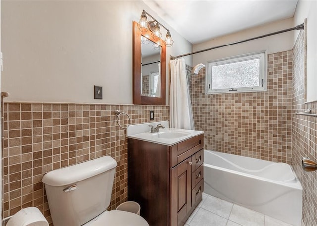 full bathroom featuring toilet, tile walls, vanity, shower / bath combination with curtain, and tile patterned flooring