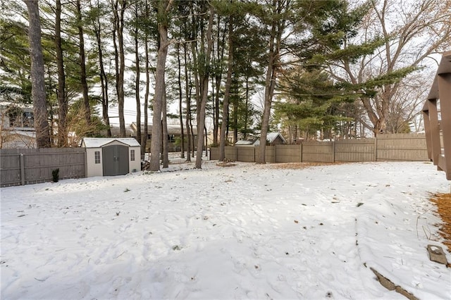 yard layered in snow with a shed