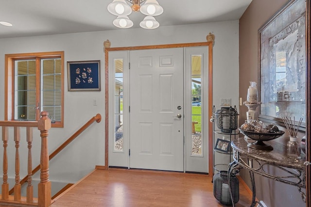 foyer with a notable chandelier and light wood-type flooring