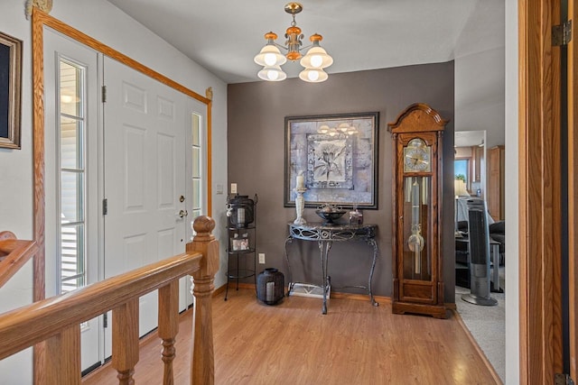 foyer entrance with a notable chandelier and light wood-type flooring