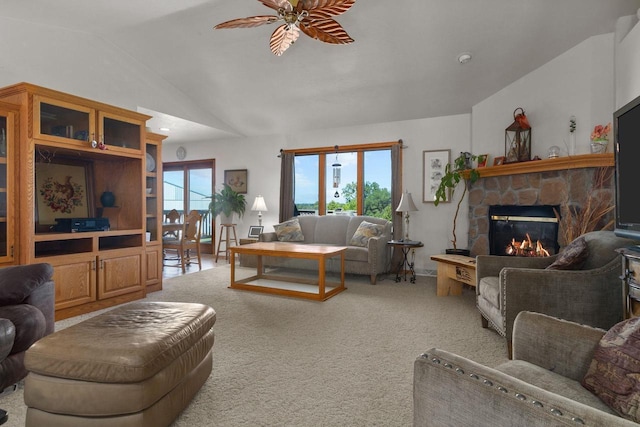 carpeted living room featuring ceiling fan, lofted ceiling, and a fireplace