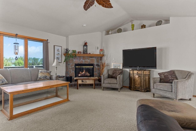 living room with ceiling fan, a fireplace, vaulted ceiling, and carpet