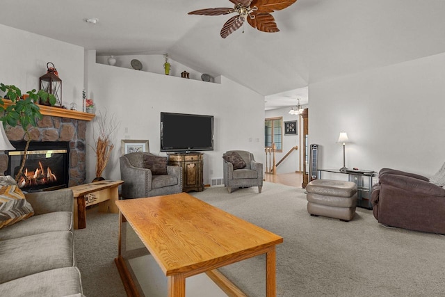 carpeted living room featuring a stone fireplace, lofted ceiling, and ceiling fan