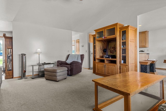 living room featuring lofted ceiling and light carpet