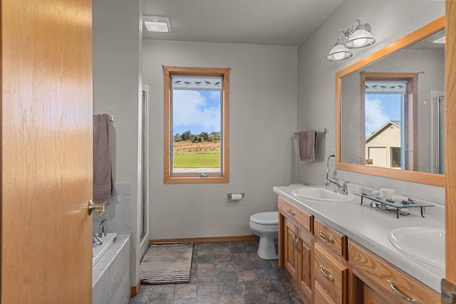 full bathroom featuring a healthy amount of sunlight, toilet, separate shower and tub, and vanity