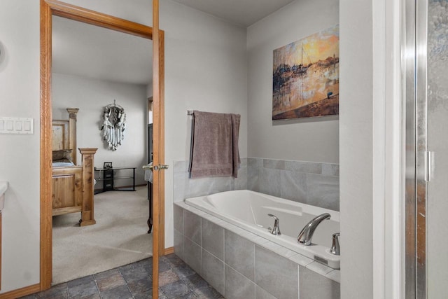 bathroom with a relaxing tiled tub