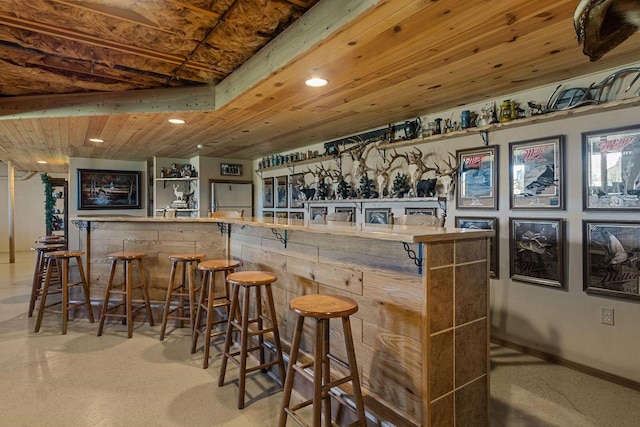 bar with stainless steel fridge and wood ceiling