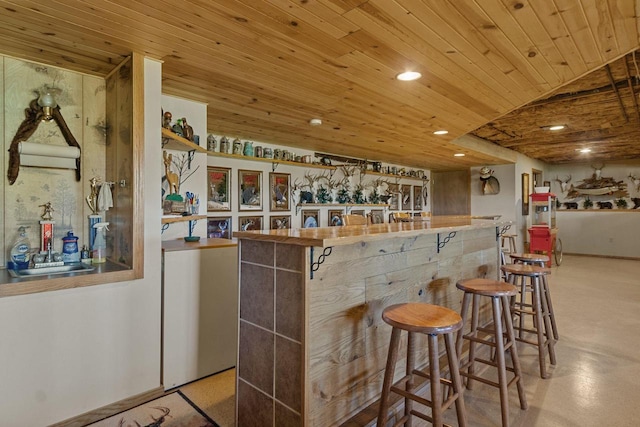 bar featuring wood ceiling and sink