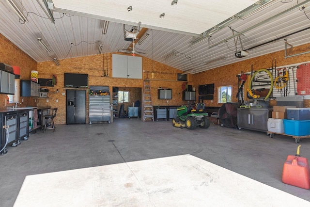 garage featuring a garage door opener and a workshop area