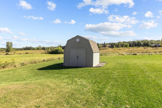 view of outbuilding featuring a yard and a rural view