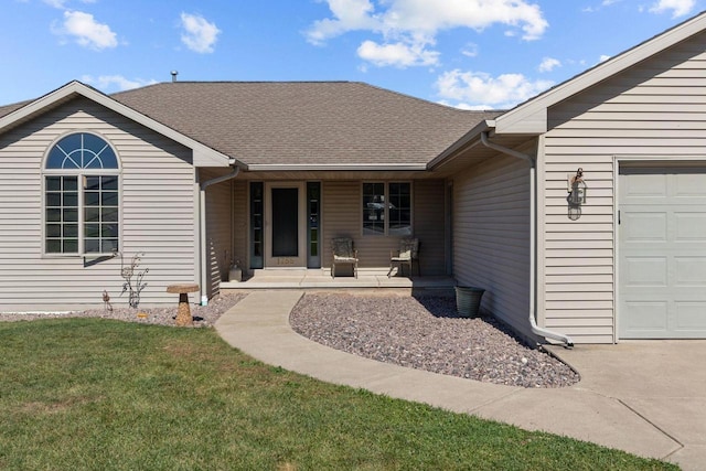 doorway to property featuring a porch, a garage, and a lawn