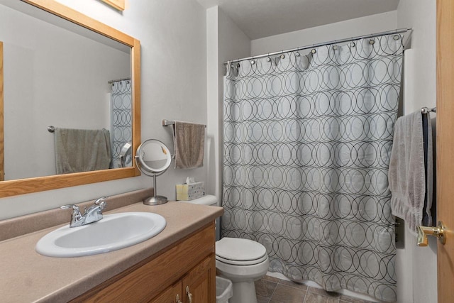 bathroom with vanity, curtained shower, tile patterned floors, and toilet