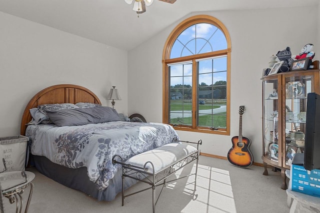 carpeted bedroom featuring vaulted ceiling and ceiling fan