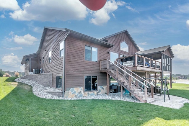 back of house with a wooden deck, central AC unit, a patio area, and a lawn