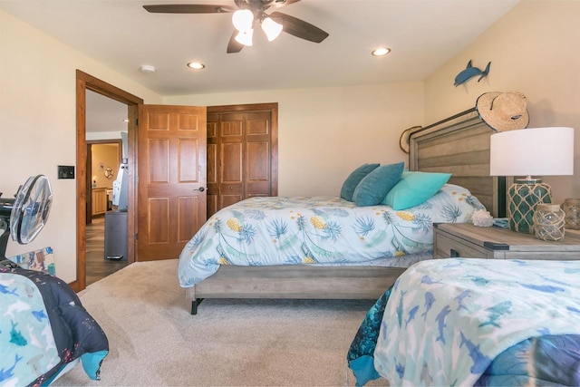 bedroom with ceiling fan, carpet flooring, and a closet