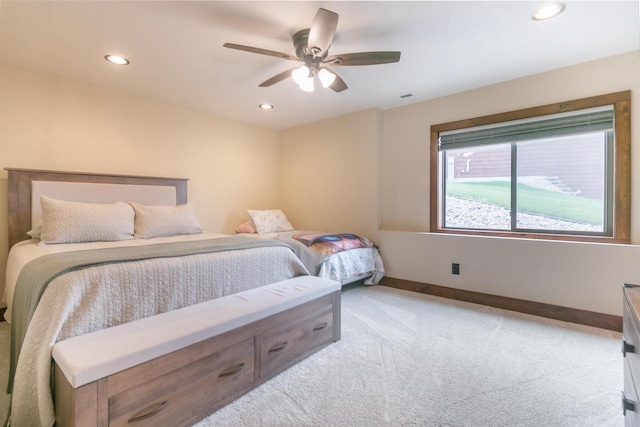 bedroom featuring light carpet and ceiling fan