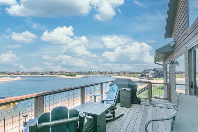 wooden terrace featuring a water view