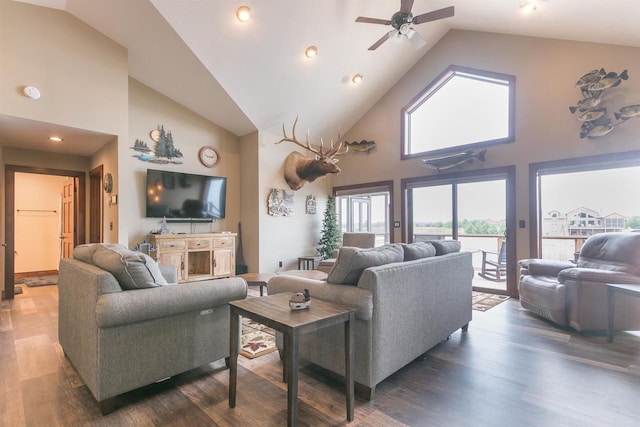 living room with ceiling fan, dark hardwood / wood-style flooring, and high vaulted ceiling