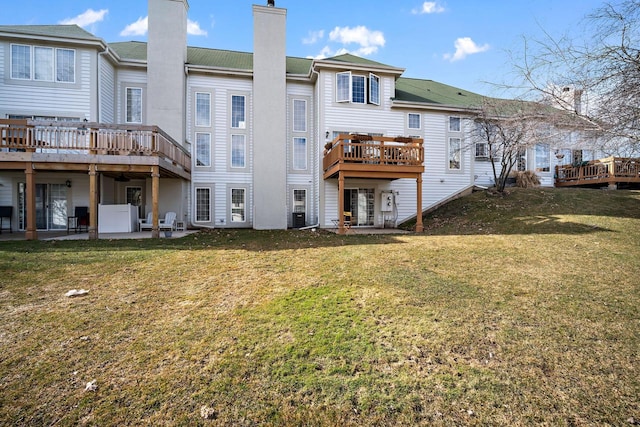 back of house with a lawn and a patio