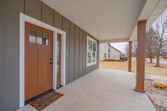 view of exterior entry with a porch