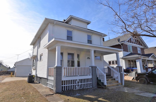 view of front of home featuring an outbuilding, a garage, central AC unit, and covered porch