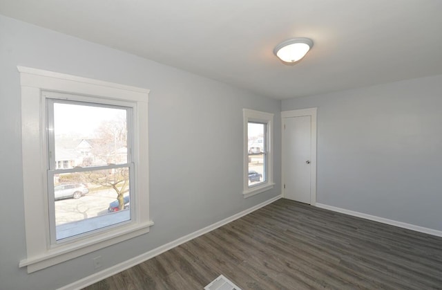 spare room with dark hardwood / wood-style flooring