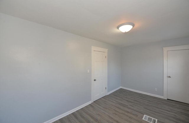 unfurnished room featuring dark hardwood / wood-style flooring