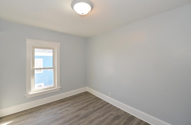 spare room with dark hardwood / wood-style flooring