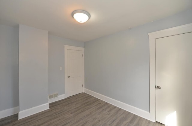 spare room with dark hardwood / wood-style floors